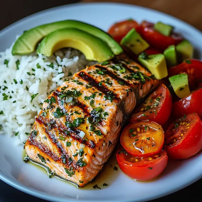 A plate of food with fish, rice, and tomatoes.