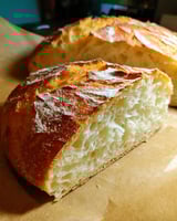 Two loaves of bread on a table.