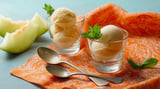 Two glasses of ice cream with mint leaves.