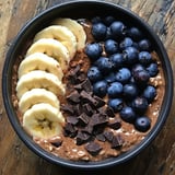 A bowl of food with bananas and blueberries.