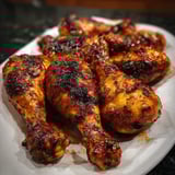 Chicken wings on a white plate.