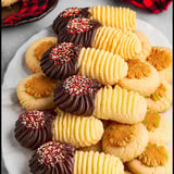 A plate of cookies with chocolate and sprinkles.