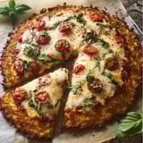 A slice of pizza with tomatoes and cheese.