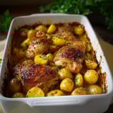 A white bowl filled with chicken and potatoes.