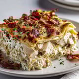 A plate of food with bacon and cheese.
