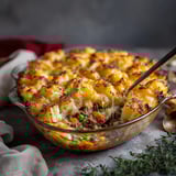 A casserole dish filled with cheese and vegetables.