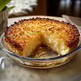 A slice of pie in a glass bowl.