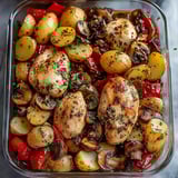A dish of chicken, potatoes, and mushrooms.