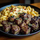 A plate of food with meat and pasta.
