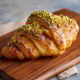 A pastry with a wooden board.